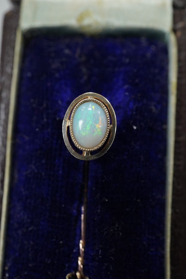 A cased late Victorian 9ct and single stone amethyst set bar brooch, 45mm, a cased yellow metal and single stone white opal set stick pin and a modern 18ct white gold, ruby and diamond cluster ring, size L/M.